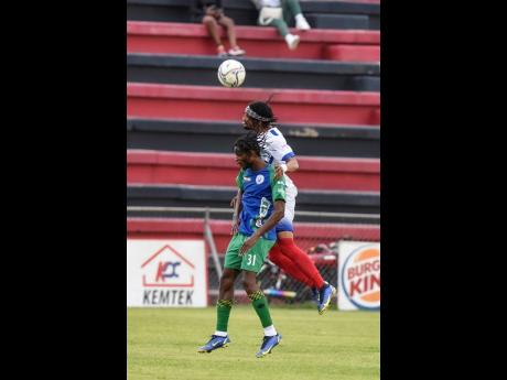 Chevoy Watkin of Portmore United FC (right) climbs above Montego Bay United’s Nazime Grant during their Jamaica Premier League game at the Anthony Spaulding Sports Complex on Monday.