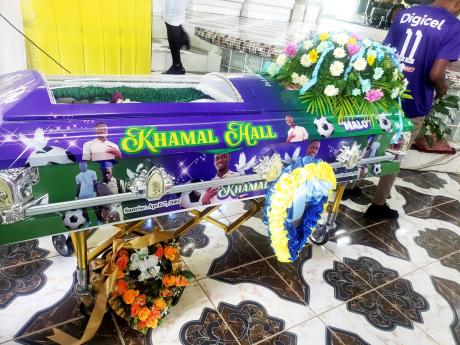 The casket bearing the remains of 16-year-old Khamal Hall who was murdered at school following a dispute over a guard ring.