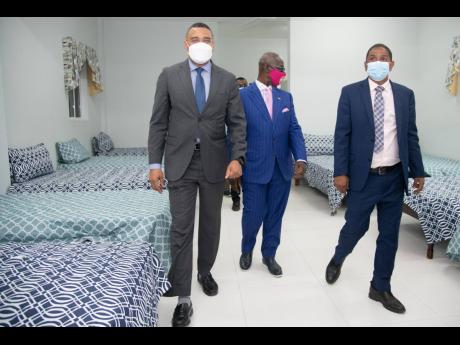 Prime Minister Andrew Holness (left) leads Local Government Minister Desmond McKenzie (centre) and Kingston’s mayor Delroy Williams on a tour of the Desmond McKenzie Transitional Centre for the Homeless, which was opened in downtown Kingston last Friday.