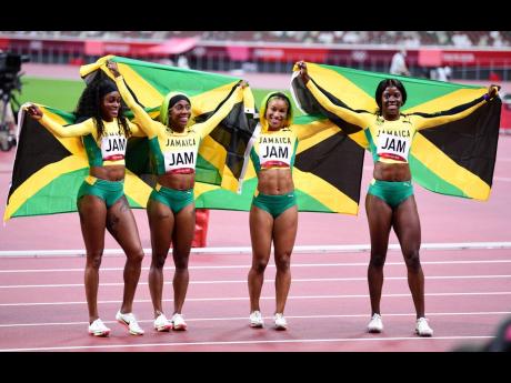Jamaica’s women’s 4x100m relay team of (from left) Elaine Thompson Herah, Shelly-Ann Fraser-Pryce, Briana Williams, and Shericka Jackson celebrate gold at the Tokyo 2020 Olympics Games at the Tokyo Olympic Stadium in Japan on Friday, August 6, 2021. 