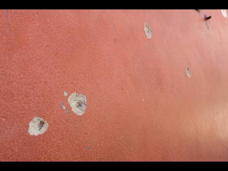 Bullet holes tell the tale of the deadly shooting.