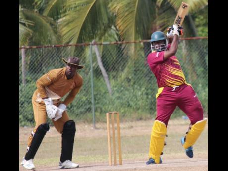 St Catherine CA opener Adrian Bartley (right) plays a shot on his way to a top score of 51 as GC Foster wicketkeeper Aaron Daley Jr looks on during their Jamaica Cricket Association All-Island 50 over encounter at Port Esquivel, St Catherine, on Saturday.