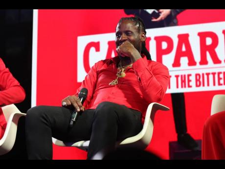 Photo by Stephanie Lyew
Dancehall star Aidonia smiles during the panel discussion segment of the Campari ‘Respect The Bitter’ launch last Saturday.