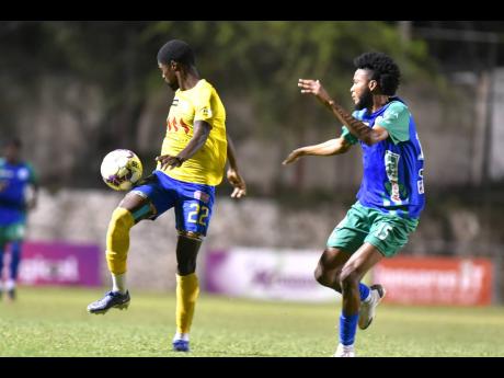 Harbour View’s Colorado Murray (let) gets away from Montego Bay’s Jevaun Shepherd during their Jamaica Premier League match at the Anthony Spaulding Sports Complex in Kingston last night.