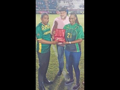 Mayor of Kingston Delroy Williams (left) presents Bobbette Shelton, widow of late former national striker Luton Shelton, with the key to the city on his behalf at halftime during the Jamaica Premier League game between Harbour View, Shelton’s former club, and Montego Bay United at the Anthony Spaulding Sports Complex in Kingston last night. Also pictured is St Andrew South Member of Parliament Mark Golding.