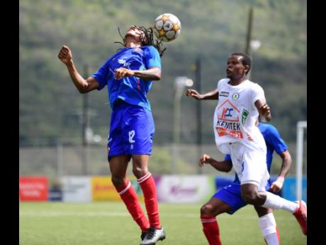 Dunbeholden FC’s Kimoni Bailey (left) heads the ball ahead of Mount Pleasant’s Donovan Segree in their Jamaica Premier League match at the UWI-JFF Captain Horace Burrell Centre of Excellence in St Andrew on Sunday, February 13.