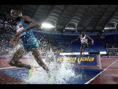 Athletes compete during the men's 3000m steeplechase.