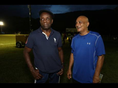 Crenston Boxhill (left) and Karam Persad in discussion at the Porus Football Festival on Sunday.