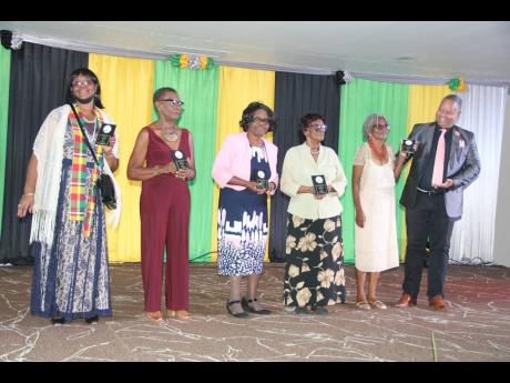 Andrew Bridger salutes the awardees (from left): Sonia Stewart, Florence Logan, Evelyn Bailey, Evelyn Dyer-Spence and Pearl Codner. 