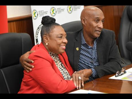 Olivia Grange (left), Minister of Culture, Gender, Entertainment and Sport, and Garth Gayle, President of  the Jamaica Athletics Administrative Association (JAAA) at yesterday’s press launch of the 2022 JAAA National Senior and Junior Championships at the JAAA headquarters on Tremaine Road in St Andrew. 