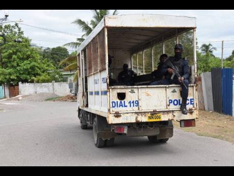 Police personnel patrol sections of Spanish Town in St Catherine.