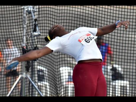 Cedricka Williams wins the under-20 female discus throw at the National Junior Championships with a national record of 56.21m at the National Stadium yesterday.