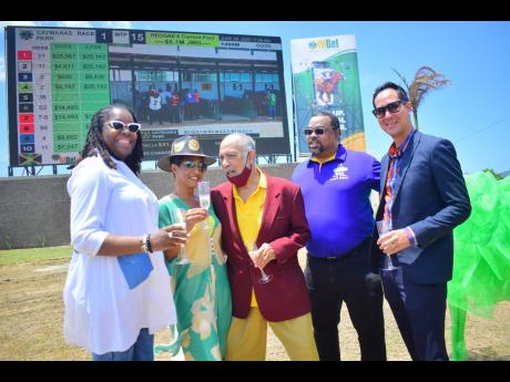 (From left) Supreme Ventures (SV) General Manager Lorna Gooden, Director Eroleen Anderson, Thoroughbred Owners and Breeders Association President Howard Hamilton, SV Chief Executive Officer Gary Peart, and SV Director Kent Levy at the official unveiling of the new tote board at Caymanas Park in St Catherine, yesterday.