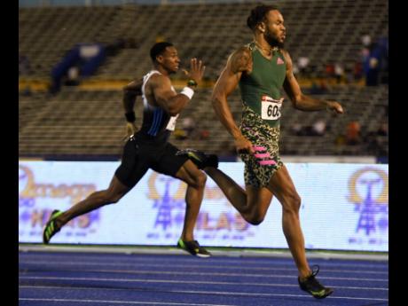 Andrew Hudson Jr (right) wins the men’s 200m final ahead of Yohan Blake at the JAAA National Senior Championships at the National Stadium in Kingston last night.