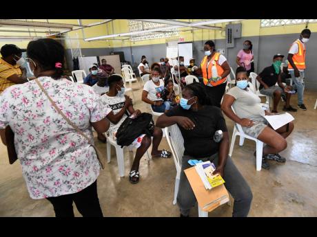 Residents of Ewarton in St Catherine gather at the community centre for the COVID-19 vaccine.