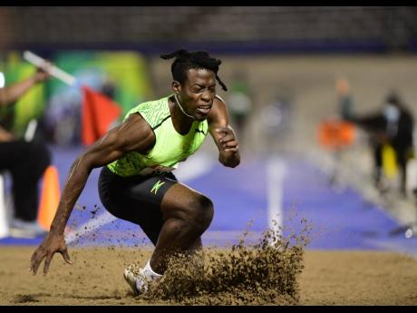 Tajay Gayle goes down injured during his participation in the men’s long jump final at the JAAA National Senior Championships at the National Stadium in Kingston on Saturday, June 25.