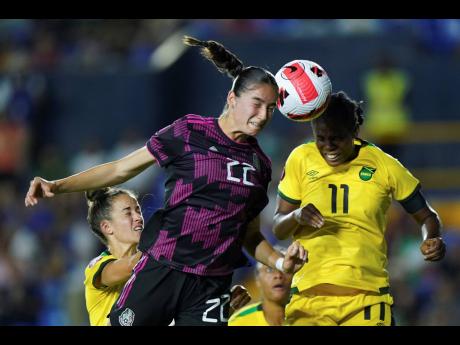 Mexico’s Diana Ordonez (left) and Jamaica’s Khadija Shaw battle for the ball during a Concacaf Women’s Championship match in Monterrey, Mexico on Monday night. Jamaica won 1-0.