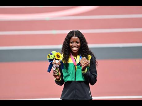Shericka Jackson shows off her bronze medal for the 100m, in which Jamaica swept to a 1-2-3 finish.