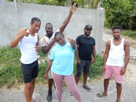 Residents of Marl Road in Shaw Park Heights, Ocho Rios, St Ann show their support for Shericka Jackson. Cheering her on are (from left) Godfrey Runners, Glenford Nelson, Shantell Powell, Ricardo Scott and Keno Roach.