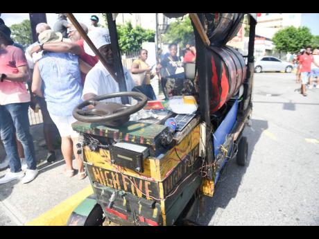 Carl ‘High 5’ Spaulding shows off his mobile jerk chicken pan.