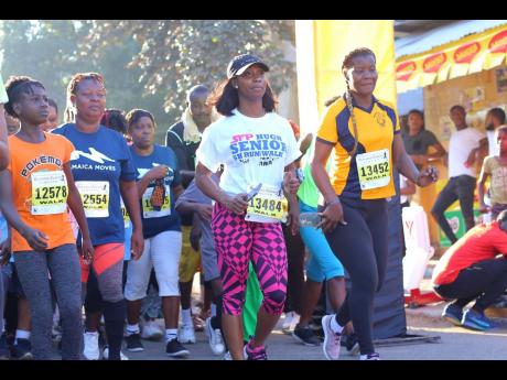 Sprinting star Shelly-Ann Farser-Pryce (second right) gets going at the start of the inaugural SFP/Hugh Senior 5k Run/Walk in 2018 in Waterhouse, St Andrew. 
