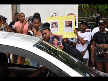 Credit: Ian Allen Relatives and friends of Donna-Lee Donaldson gathered along Chelsea Avenue in Kingston, seeking to enlist the support of Jamaicans in the search for her.
