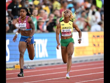 Shelly-Ann Fraser-Pryce crosses the line in first to take her fifth World 100m title at the World Athletics Championships in Eugene, Oregon, last night. Also pictured is the United States of America’s Aleia Hobbs.