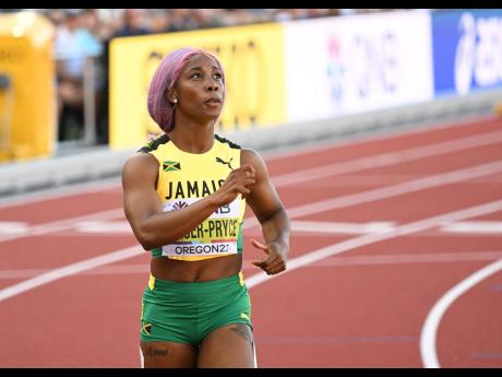 Shelly-Ann Fraser-Pryce looks at the clock after storming to a fast 21.82 seconds to clinch her semi-final heat at the World Athletics Championships in Eugene, Oregon last night.