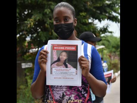 Family and friends of Donna-Lee Donaldson gather near the Constant Spring Police Station in St Andrew as they continue to protest her disappearance.