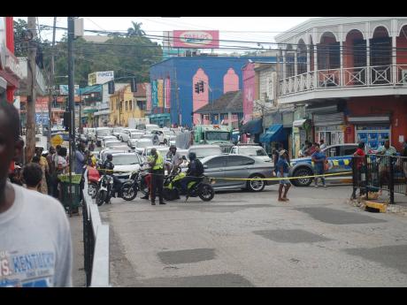 Police at the scene of a gunfight that unfolded in Sam Sharpe Square, Montego Bay, on Tuesday.