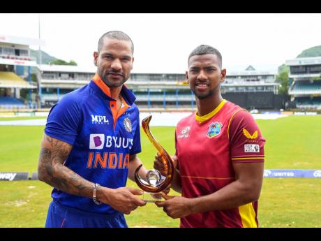 Captains Nicholas Pooran (West Indies, right) and Shikhar Dhawan (India) with the series trophy at Queen’s Park Oval.