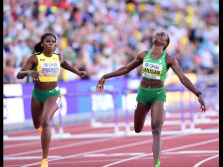 Jamaica’s Britany Anderson (left) crossing the finish line to take silver in the Women’s 100m Hurdles final at the World Athletics Championships in Eugene, Oregon, last night. The event was won by world record holder Tobi Amusan of  Nigeria (right) in a wind-aided 12.06 seconds.