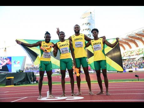 Jamaica’s Men’s 4x400m relay team of (from left) Christopher Taylor, Nathon Allen, Akeem Bloomfield, and Jevaughn Powell celebrate taking silver in the final at the World Athletics Championships in Eugene, Oregon, last night.