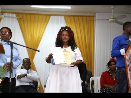 Gwendolyn McKnight shows the nursing certificate that was presented to her daughter Kemesha Wright posthumously.