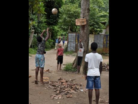 Credit: Ian Allen Children in Kent Village, St Catherine, who normally swim in the Rio Cobre during the summer break now find other games to play.