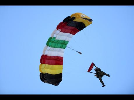 One of the paratroopers from Guyana descending on the National Stadium.