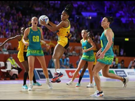 Jamaica’s Adean Thomas (centre) wins the ball in front of Australia’s Ashleigh Brazill (right) during the netball competition’s gold medal match on day 10 of the 2022 Commonwealth Games in Birmingham, England on Sunday.