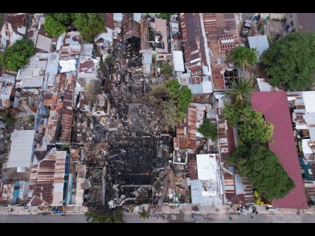 Credit: Ricardo Makyn left: An aerial view of the damage to the homes.