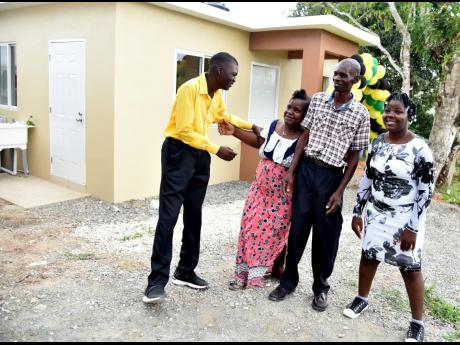 The Tucker family (from left) Delano, Nattris, Denisha, and Desmond were overcome with emotions after receiving their new home.