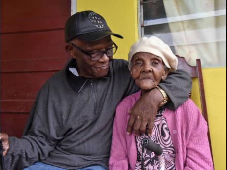 Naomi Richards-Tucker (right),  shares a moment with her brother Edmond Richards at her home in St Catherine.