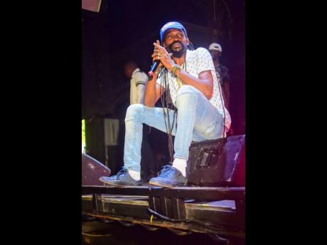 Munga Honorable takes a seat during his performance.