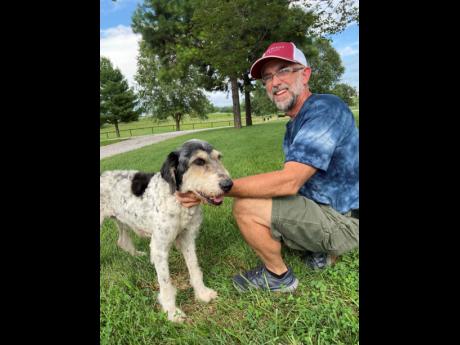 This image provided by Jeff Bohnert and taken by his wife, Kathy Bohnert, shows him and his dog, Abby, in August, just days after cavers found Abby inside a cave not far from her home in Perryville, Missouri. She was found on August 6. (Kathy Bohnert via AP)