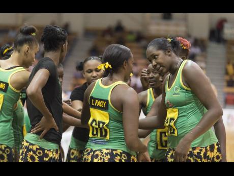 Jamaica’s Sunshine Girls captain, Jhaniele Fowler (right), speaking with teammates during a team huddle.