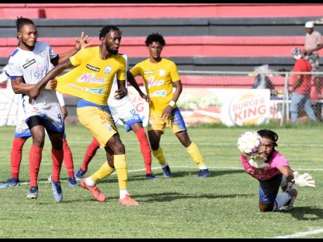 Portmore United goalkeeper Benjamin Williams (right) saves a shot on goal from  Jeremy Nelson (second left) of Molynes United during their Jamaica Premier League football match at the Anthony Spaulding Sports Complex last season.  Also in the photograph are Stephen Young (left) of Portmore United and Revaldo Mitchell (second right) of Molynes United.