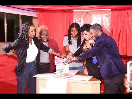 Credit: Nicholas Nunes/Photographer Recording artiste Ishawna (second right) cuts the celebratory cake with members of THE STAR team (from left) Shanel Lemmie, Simone Morgan-Lindo, Tiffany Taylor and Roxroy McLean.