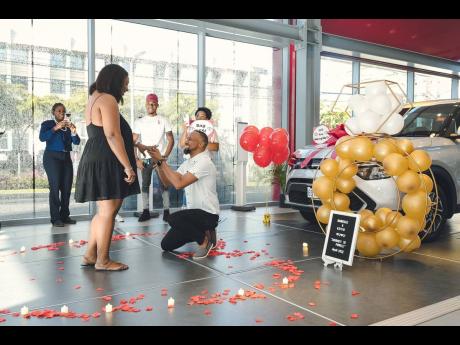 Credit: Contributed Kevin Powell asks Shaneille Bramwell to be his wife at Kia Jamaica headquarters on Oxford Road, St Andrew.