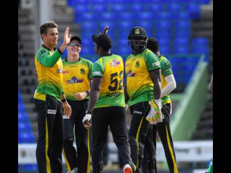 Chris Green (left) and his Jamaica Tallawahs teammates celebrate the fall of a wicket during a match against the Guyana Amazon Warriors in the 2021 Hero Caribbean Premier League at Warner Park Sporting Complex in St Kitts and Nevis.