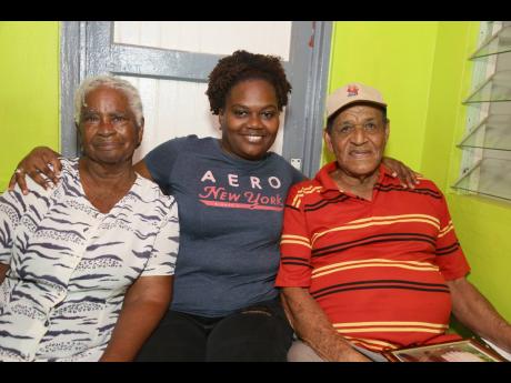 Shaneca Slowley (centre) shares a moment with her grandparents Eunice and Trevor Sherman.