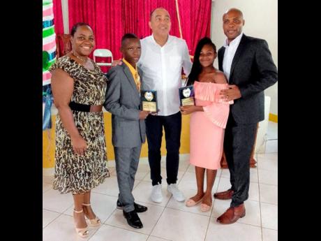 Member of Parliament for St Catherine West Central, Dr Christopher Tufton (centre), with (from left) Regional Director at the Ministry of Education and Youth, Sophia Forbes Hall, top male student in the Primary Exit Profile in the constituency, Milo-Rich Thomas, top female student Kayanna Gonzales, and Principal of the Friendship Primary School, Collington Powell. They were at an event held recently at the Watermount Open Bible Church.

 