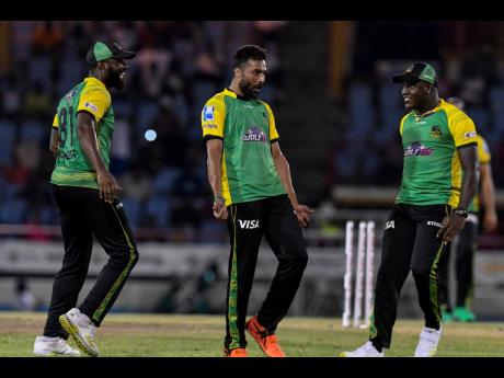 Mohammad Amir (centre), Raymon Reifer (left) and Rovman Powell of Jamaica Tallawahs celebrate the dismissal of Faf Du Plessis of St Lucia Kings during their Caribbean Premier League match at Daren Sammy National Cricket Stadium yesterday.